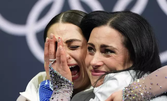Julia Sauter of Romania reacts to her score after competing in the women's figure skating free program at the 2026 Winter Olympics, in Milan, Italy, Thursday, Feb. 19, 2026. (AP Photo/Stephanie Scarbrough)