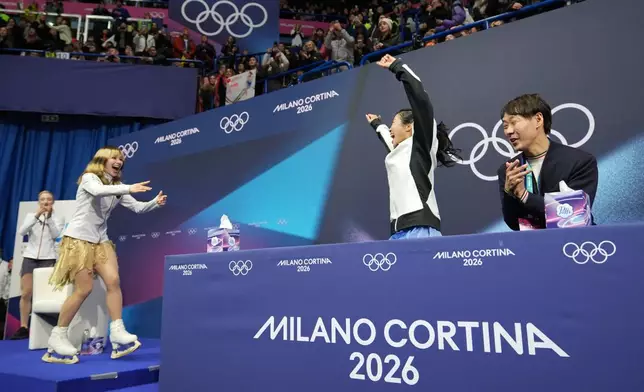 Ami Nakai of Japan reacts to her score that won her a bronze as Alysa Liu of the United States realizes she won the gold after competing in the women's figure skating free program at the 2026 Winter Olympics, in Milan, Italy, Thursday, Feb. 19, 2026. (AP Photo/Stephanie Scarbrough)