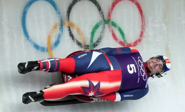 USA's Matthew Greiner slides down the track during a men's Luge training session at the 2026 Winter Olympics, in Cortina d'Ampezzo, Italy, Thursday, Feb. 5, 2026. (AP Photo/Aijaz Rahi)
