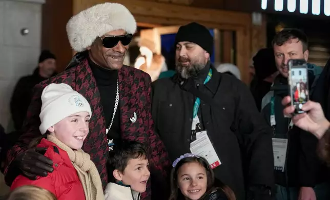 Rapper Snoop Dogg poses for a photo prior to the Olympic opening ceremony at the 2026 Winter Olympics, in Cortina d'Ampezzo, Italy, Friday, Feb. 6, 2026. (AP Photo/Misper Apawu)