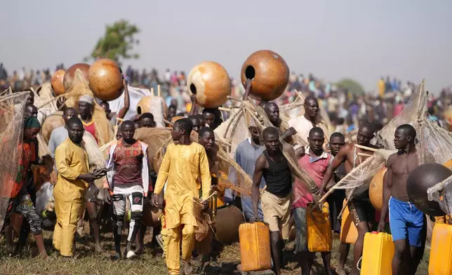 Fishermen arrive for the Argungu cultural fishing festival in Argungu, Kebbi , Northern Nigeria, Saturday, Feb.14, 2026. (AP Photo/Sunday Alamba)