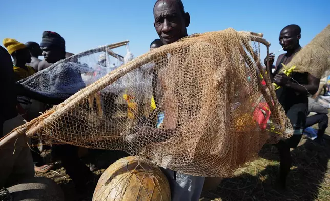 Fishermen wait for the start of the Argungu cultural fishing festival in Argungu, Kebbi , Northern Nigeria, Saturday, Feb.14, 2026. (AP Photo/Sunday Alamba)