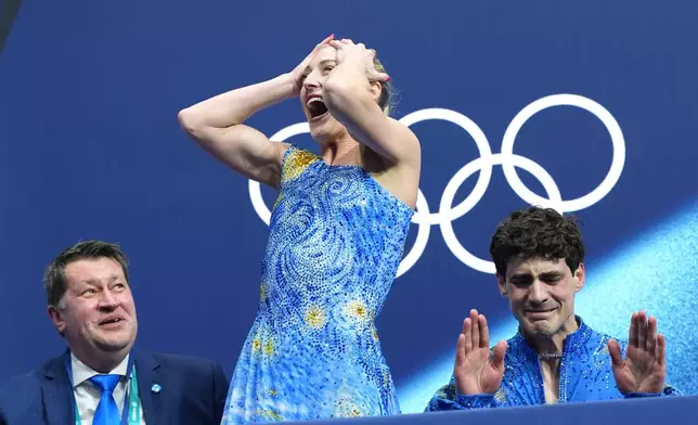 Piper Gilles, center, and Paul Poirier, right, of Canada react to their scores after competing during the ice dancing free skate in figure skating at the 2026 Winter Olympics, in Milan, Italy, Wednesday, Feb. 11, 2026. (AP Photo/Stephanie Scarbrough)