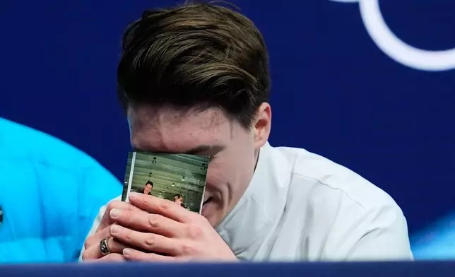 Maxim Naumov of the United States reacts to his scores after competing during the men's free skate program in figure skating at the 2026 Winter Olympics, in Milan, Italy, Friday, Feb. 13, 2026. (AP Photo/Francisco Seco)