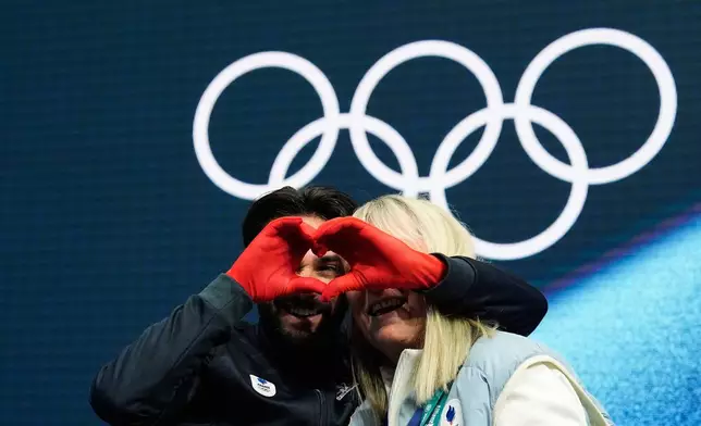 Kevin Aymoz of France reacts to his scores after competing during the men's free skate program in figure skating at the 2026 Winter Olympics, in Milan, Italy, Friday, Feb. 13, 2026. (AP Photo/Ashley Landis)