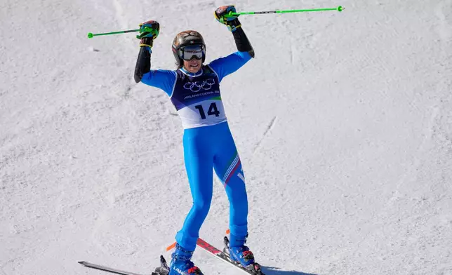 Italy's Federica Brignone celebrates at the finish area of an alpine ski, women's giant slalom race, at the 2026 Winter Olympics, in Cortina d'Ampezzo, Italy, Sunday, Feb. 15, 2026. (AP Photo/Andy Wong)