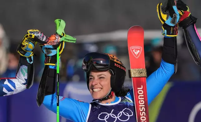 Italy's Federica Brignone celebrates winning an alpine ski, women's giant slalom race, at the 2026 Winter Olympics, in Cortina d'Ampezzo, Italy, Sunday, Feb. 15, 2026. (AP Photo/Jacquelyn Martin)