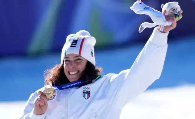Italy's Federica Brignone shows the gold medal of an alpine ski, women's giant slalom race, at the 2026 Winter Olympics, in Cortina d'Ampezzo, Italy, Sunday, Feb. 15, 2026. (AP Photo/Robert F. Bukaty)
