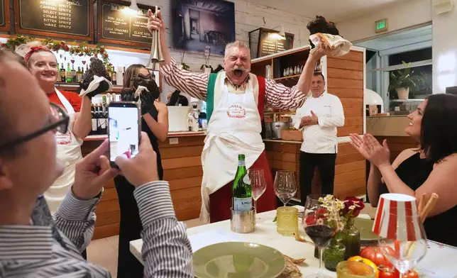 Butcher Dario Ceccini of Italy, welcomes guests to a private dinner at the South Beach Wine and Food Festival Saturday, Feb. 21, 2026, in Miami Beach, Fla. (AP Photo/Marta Lavandier)