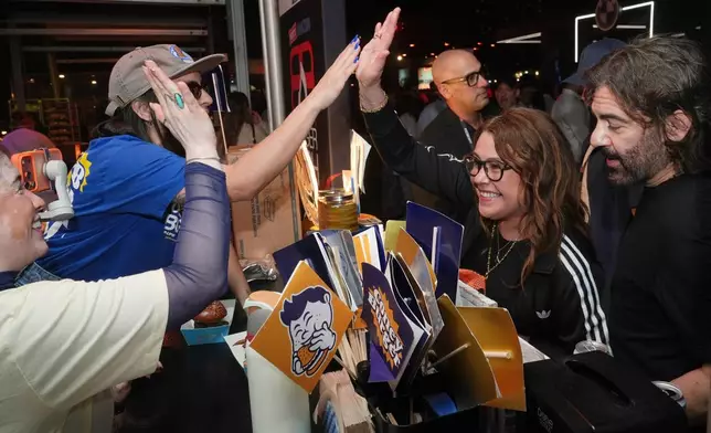 Professional cook Rachel Ray congratulates the staff at Coney Burger during the Burger Bash at the South Beach Wine and Food Festival Friday, Feb. 20, 2026, in Miami Beach, Fla. (AP Photo/Marta Lavandier)