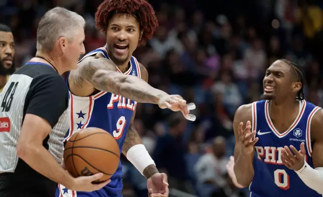 Philadelphia 76ers guard Kelly Oubre Jr. (9) and guard Tyrese Maxey (0) argue a call during the first half of an NBA basketball game against the New Orleans Pelicans in New Orleans, Saturday, Feb. 21, 2026. (AP Photo/Matthew Hinton)