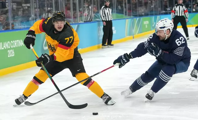 Germany's John Peterka (77) moves the puck against France's Florian Chakiachvili (62) during the second period of a men's ice hockey qualification playoff game at the 2026 Winter Olympics, in Milan, Italy, Tuesday, Feb. 17, 2026. (AP Photo/Carolyn Kaster)