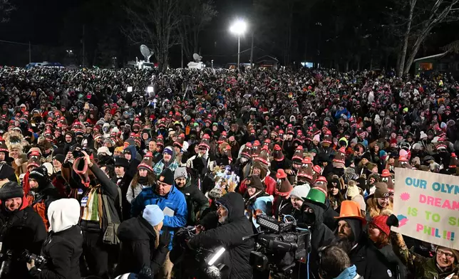 A crowd gathers while waiting for Punxsutawney Phil, the weather prognosticating groundhog, to come out and make his prediction during the 140th celebration of Groundhog Day on Gobbler's Knob in Punxsutawney, Pa., Monday, Feb. 2, 2026. (AP Photo/Barry Reeger)