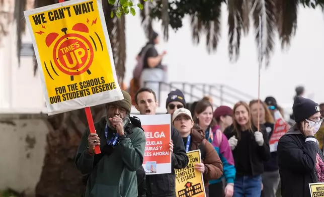 Teachers, students and supporters picket outside of Mission High School in San Francisco, Monday, Feb. 9, 2026. (AP Photo/Jeff Chiu)