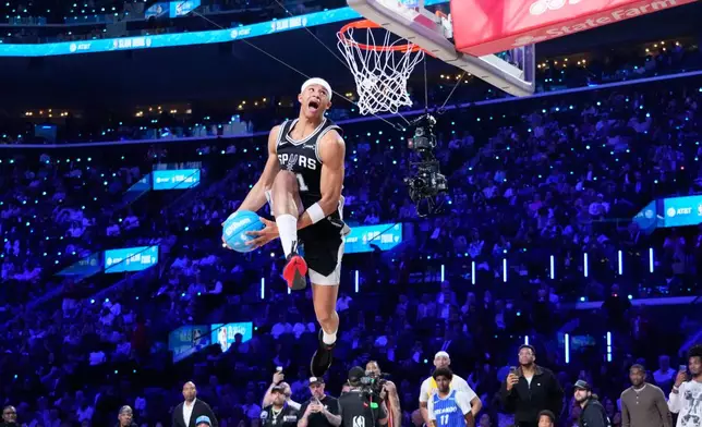 San Antonio Spurs forward Carter Bryant dunks during the slam dunk contest at the NBA basketball All-Star weekend festivities Saturday, Feb. 14, 2026, in Inglewood, Calif. (AP Photo/Mark J. Terrill)