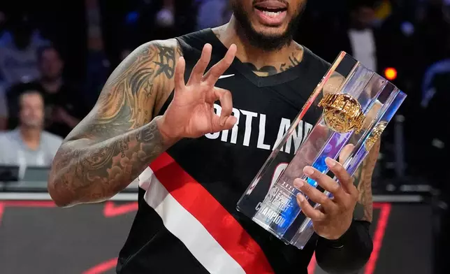 Portland Trailblazers guard Damian Lillard hols the winner's trophy after the 3-point contest at the NBA basketball All-Star weekend festivities Saturday, Feb. 14, 2026, in Inglewood, Calif. (AP Photo/Mark J. Terrill)