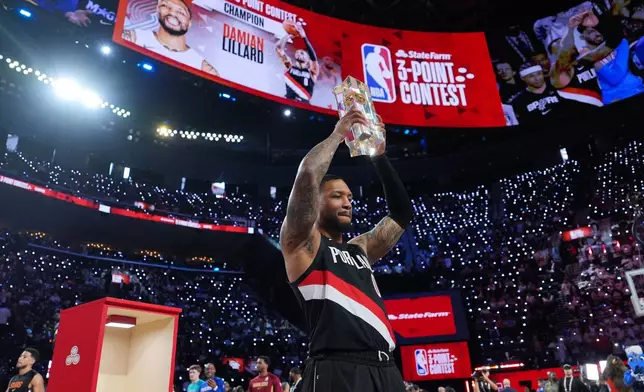 Portland Trailblazers guard Damian Lillard holds the winner's trophy after the 3-point contest at the NBA basketball All-Star weekend festivities Saturday, Feb. 14, 2026, in Inglewood, Calif. (AP Photo/Jae C. Hong)