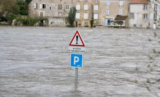A flooded road with a sign reading "risk of flooding" is seen in Confolens as severe flooding hits western France amid storm Nils, Thursday, Feb. 12, 2026. (AP Photo/Yohan Bonnet)