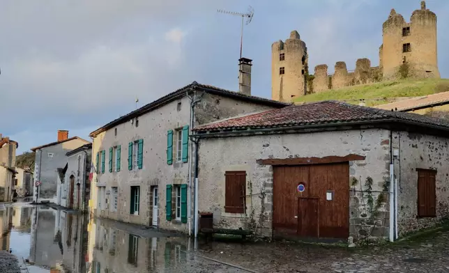 Water sits along a flooded street in Saint-Germain de Confolens in western France amid storm Nils, Thursday, Feb. 12, 2026. (AP Photo/Yohan Bonnet)