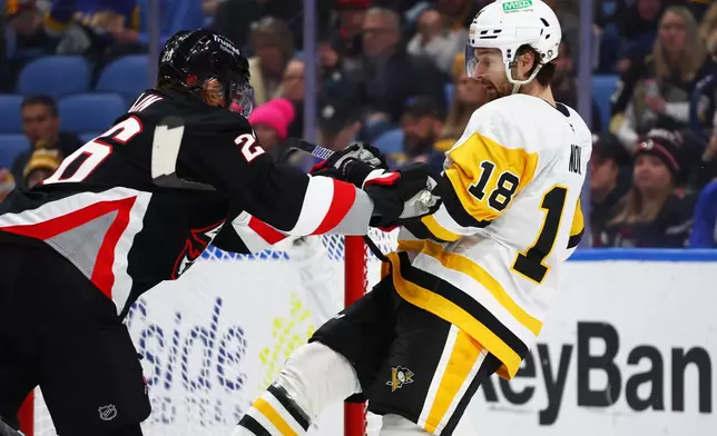 Pittsburgh Penguins center Tommy Novak (18) is stick checked by Buffalo Sabres defenseman Rasmus Dahlin during the second period of an NHL hockey game, Thursday, Feb. 5, 2026, in Buffalo, N.Y. (AP Photo/Jeffrey T. Barnes)
