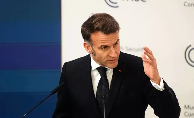 French President Emmanuel Macron addresses the audience during a session at the Munich Security Conference in Munich, Germany, Friday, Feb. 13, 2026. (AP Photo/Michael Probst)