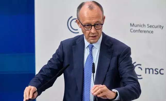 Germany's Chancellor Friedrich Merz prepares to address the audience during the Munich Security Conference in Munich, Germany, Friday, Feb. 13, 2026. (AP Photo/Michael Probst)