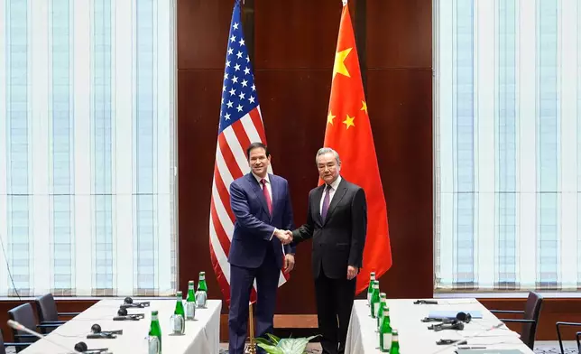 Secretary of State Marco Rubio shakes hands with China's Foreign Minister Wang Yi in Munich, Germany, Friday, Feb. 13, 2026, at the beginning of a meeting on the sidelines of the Munich Security Conference. (AP Photo/Alex Brandon, Pool)