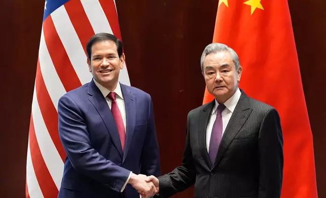 Secretary of State Marco Rubio shakes hands with China's Foreign Minister Wang Yi in Munich, Germany, Friday, Feb. 13, 2026, at the beginning of a meeting on the sidelines of the Munich Security Conference. (AP Photo/Alex Brandon, Pool)