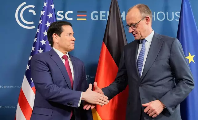 U.S. Secretary of State Marco Rubio, left, and Germany's Chancellor Friedrich Merz shake hands in Munich, Germany, Friday, Feb. 13, 2026, at the the Munich Security Conference. (AP Photo/Alex Brandon, Pool)