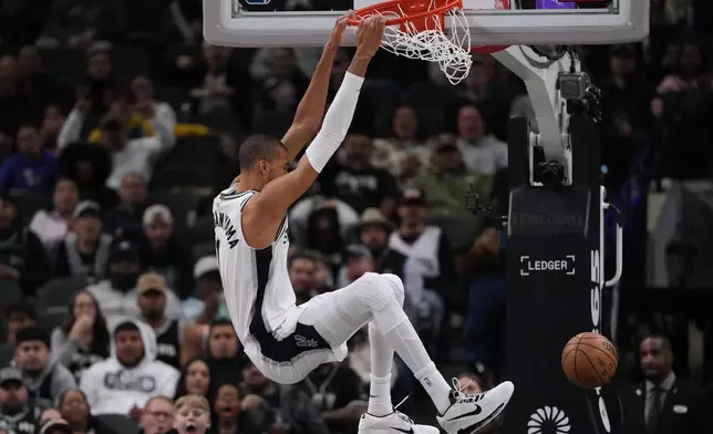 San Antonio Spurs forward Victor Wembanyama (1) scores against the Orlando Magic during the first half of an NBA basketball game in San Antonio, Sunday, Feb. 1, 2026. (AP Photo/Eric Gay)