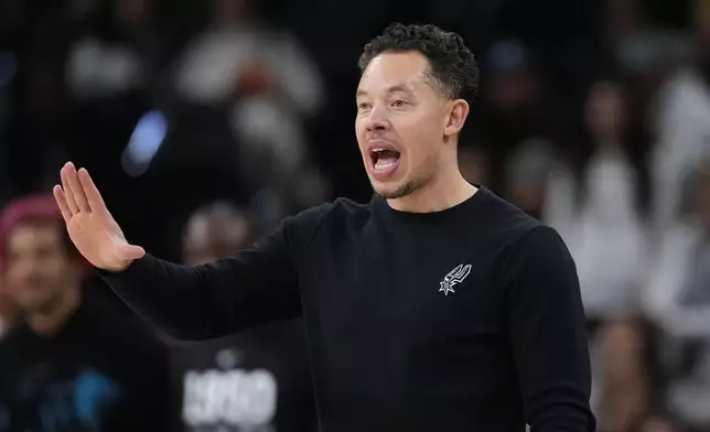 San Antonio Spurs head coach Mitch Johnson signals to his players during the second half of an NBA basketball game against the Orlando Magic in San Antonio, Sunday, Feb. 1, 2026. (AP Photo/Eric Gay)