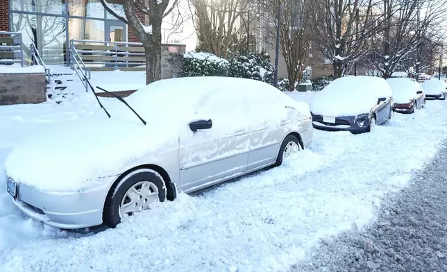 Snow covers parked cars, Sunday, Feb 1, 2026, in Charlotte, N.C. (AP Photo/Matt Kelley)