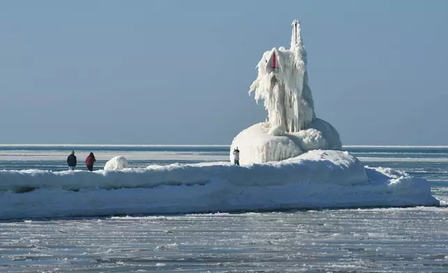 Ice covers a navigational beacon at the end of the South Pier along Lake Michigan, Friday, Feb. 13, 2026, in St. Joseph, Mich. (Don Campbell/The Herald-Palladium via AP)