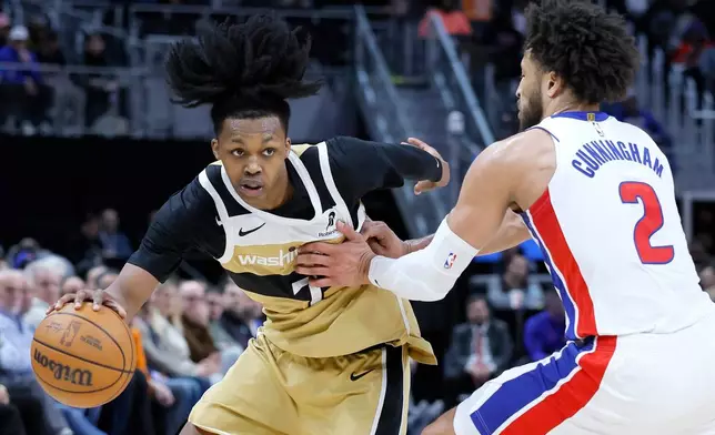 Washington Wizards guard Bub Carrington (7) drives against Detroit Pistons guard Cade Cunningham (2) during the first half of an NBA basketball game Thursday, Feb. 5, 2026, in Detroit. (AP Photo/Duane Burleson)