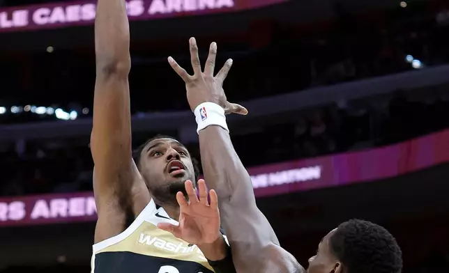 Washington Wizards center Alex Sarr (20) takes a shot over Detroit Pistons center Jalen Duren (0) during the first half of an NBA basketball game Thursday, Feb. 5, 2026, in Detroit. (AP Photo/Duane Burleson)
