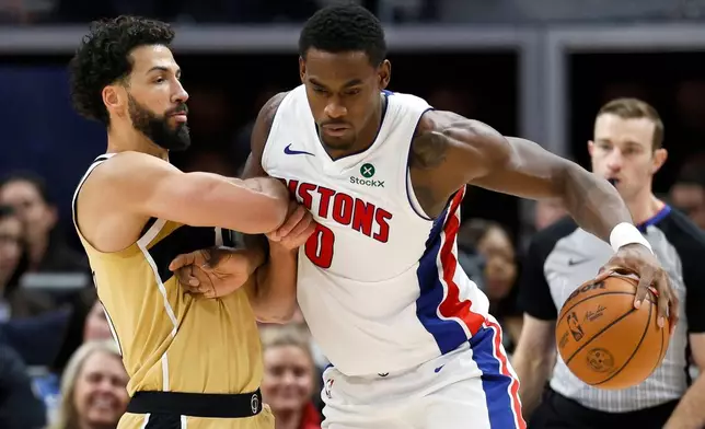 Detroit Pistons center Jalen Duren (0) drives against Washington Wizards forward Anthony Gill during the first half of an NBA basketball game, Thursday, Feb. 5, 2026, in Detroit. (AP Photo/Duane Burleson)
