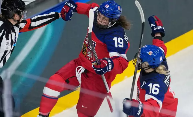 Czechia's Natalie Mlynkova, left, celebrates with Czechia's Katerina Mrazova after scoring her sides second goal during a preliminary round match of women's ice hockey between Czechia vs Finland at the 2026 Winter Olympics, in Milan, Italy, Sunday, Feb. 8, 2026. (AP Photo/Hassan Ammar)