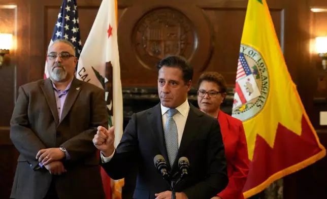 FILE - Los Angeles District Superintendent Alberto Carvalho, at podium, holds a news conference as SEIU Local 99 Executive Director Max Arias, left, and Los Angeles Mayor Karen Bass, right, listen, in Los Angeles City Hall, Friday, March 24, 2023. (AP Photo/Damian Dovarganes, File)