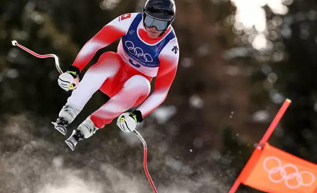 Switzerland's Franjo von Allmen speeds down the course during an alpine ski, men's downhill race, at the 2026 Winter Olympics, in Bormio, Italy, Saturday, Feb. 7, 2026. (AP Photo/Gabriele Facciotti)