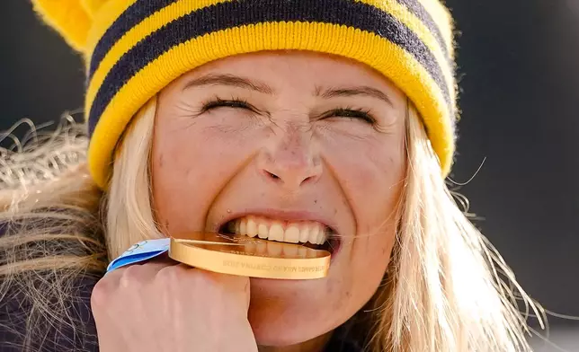 Frida Karlsson of Sweden poses with her gold medal after the cross country skiing women's 10km + 10km skiathlon at the 2026 Winter Olympics, in Tesero, Italy, Saturday, Feb. 7, 2026. (AP Photo/Matthias Schrader)