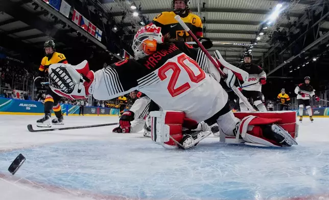 Germany's Emily Nix scores her side's third goal during a preliminary round match of women's ice hockey between Germany and Japan at the 2026 Winter Olympics, in Milan, Italy, Saturday, Feb. 7, 2026. (AP Photo/Darko Bandic, Pool)