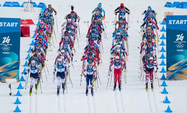 Jessie Diggins of the United States, center, and others start in the cross country skiing women's 10km + 10km skiathlon at the 2026 Winter Olympics, in Tesero, Italy, Saturday, Feb. 7, 2026. (AP Photo/Matthias Schrader)