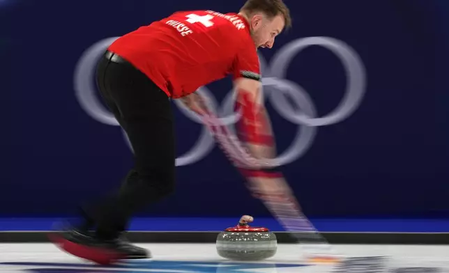 Switzerland's Yannick Schwaller in action during the mixed doubles round robin phase of the curling competition against Sweden at the 2026 Winter Olympics, in Cortina d'Ampezzo, Italy, Saturday, Feb. 7, 2026. (AP Photo/Fatima Shbair)