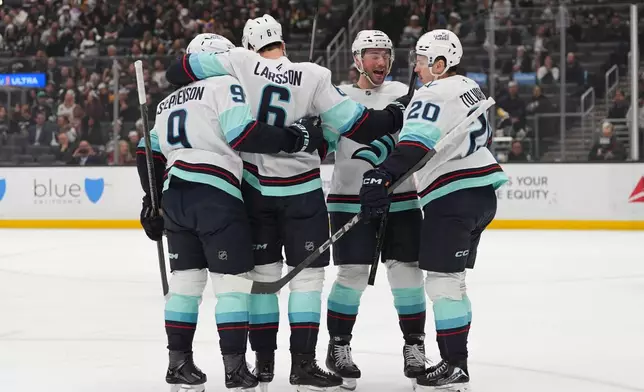 Seattle Kraken defenseman Adam Larsson (6) celebrates his goal with teammates during the first period of an NHL hockey game against the Los Angeles Kings Wednesday, Feb. 4, 2026, in Los Angeles. (AP Photo/Jae C. Hong)