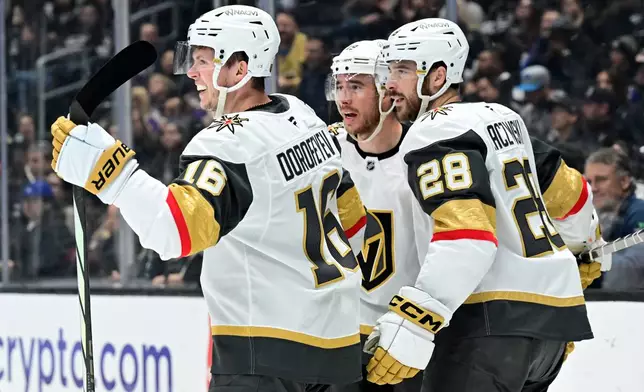Vegas Golden Knights right wing Pavel Dorofeyev (16) celebrate his goal against the Los Angeles Kings with right wing Reilly Smith, center, and center Tanner Laczynski (28) in the first period of an NHL hockey game Wednesday, Feb. 25, 2026, in Los Angeles. (AP Photo/Wally Skalij)