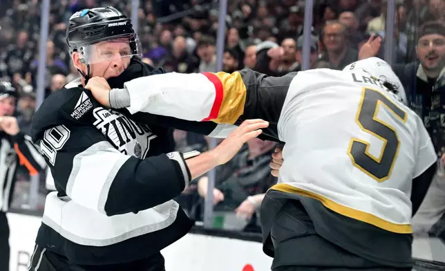 Los Angeles Kings right wing Corey Perry (10) and Vegas Golden Knights defenseman Jeremy Lauzon (5) fight in the second period of an NHL hockey game Wednesday, Feb. 25, 2026, in Los Angeles. (AP Photo/Wally Skalij)