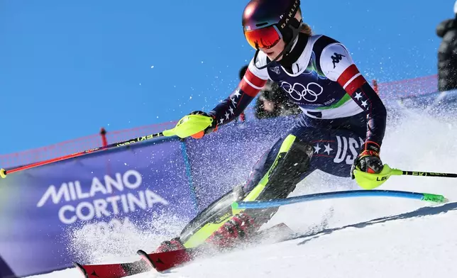 United States' Mikaela Shiffrin speeds down the course during an alpine ski, women's slalom race, at the 2026 Winter Olympics, in Cortina d'Ampezzo, Italy, Wednesday, Feb. 18, 2026. (AP Photo/Marco Trovati)