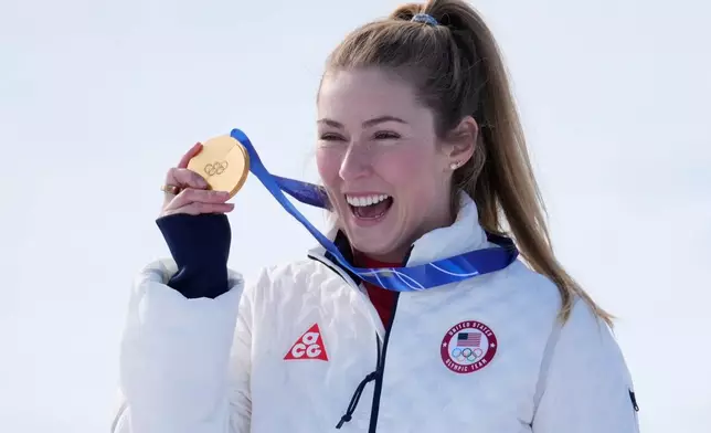 United States' Mikaela Shiffrin shows her gold medal of the alpine ski, women's slalom race, at the 2026 Winter Olympics, in Cortina d'Ampezzo, Italy, Wednesday, Feb. 18, 2026. (AP Photo/Robert F. Bukaty)