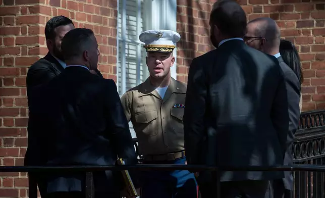 FILE - U.S. Marine Corp Major Joshua Mast, center, talks with his attorneys during a break in the hearing of an ongoing custody battle over an Afghan orphan, March 30, 2023, at the Circuit Courthouse in Charlottesville, Va. (AP Photo/Cliff Owen, File)