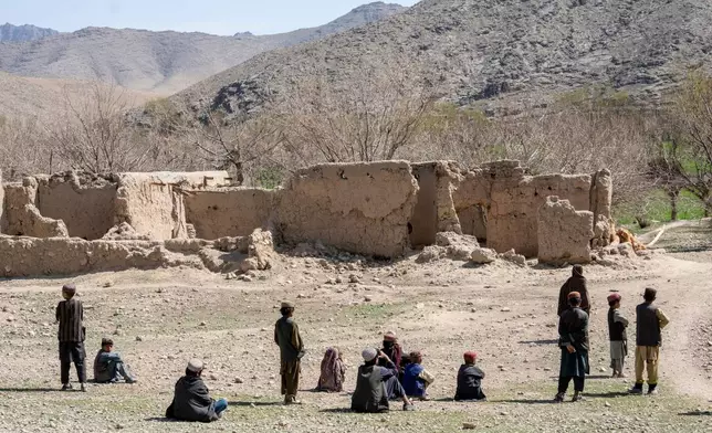 FILE - Children stand in front of a home destroyed during a Sept. 5, 2019, night raid by U.S. forces in a village in a remote region of Afghanistan, on Friday, Feb. 24, 2023. (AP Photo/Ebrahim Noroozi, File)